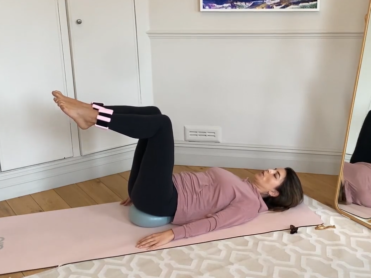 A silver tray with halved eggs topped with a salad filling and trout roe, and herbs sprinkled on top.