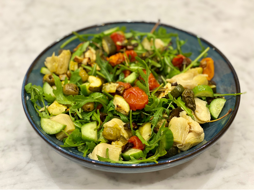 A salad of roasted vegetables in a bowl dressed and tossed - a gluten-free, gut-friendly, anti-inflammatory diet recipe.